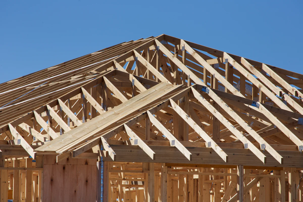 Wood roof trusses and wall framing on a house under construction