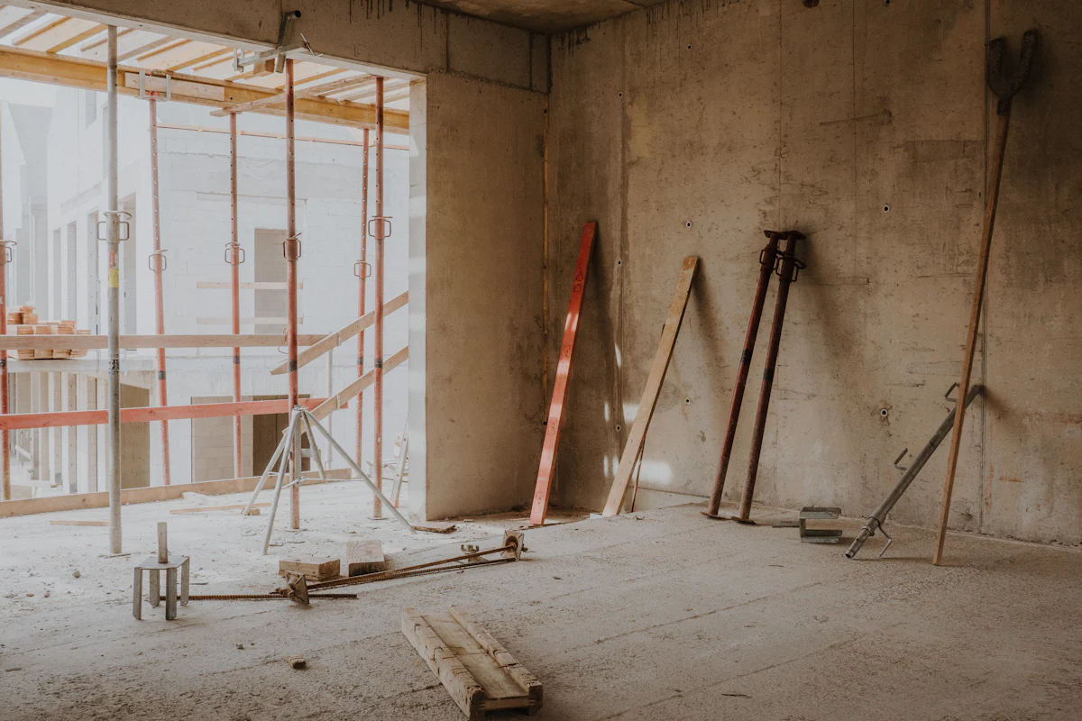 An interior under renovation with scaffolding and exposed framing