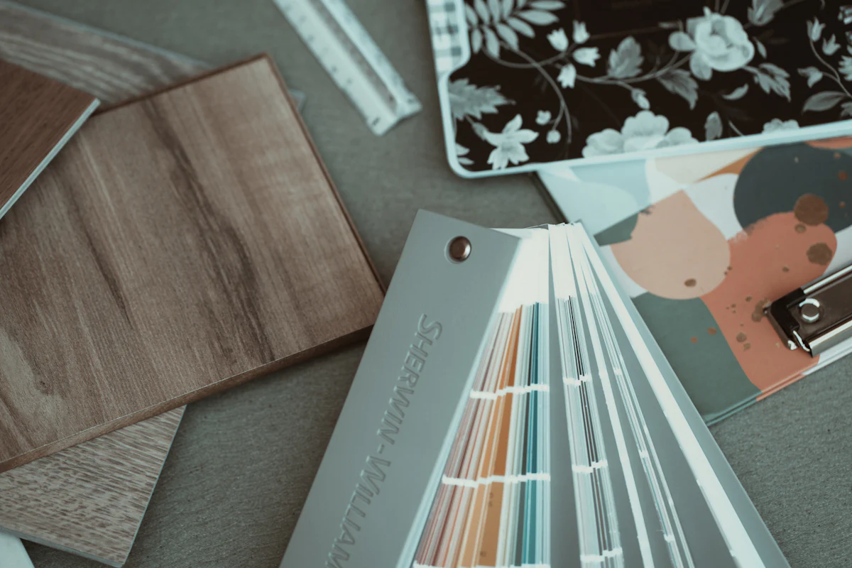 Wood flooring samples and a paint fan deck laid out for selections