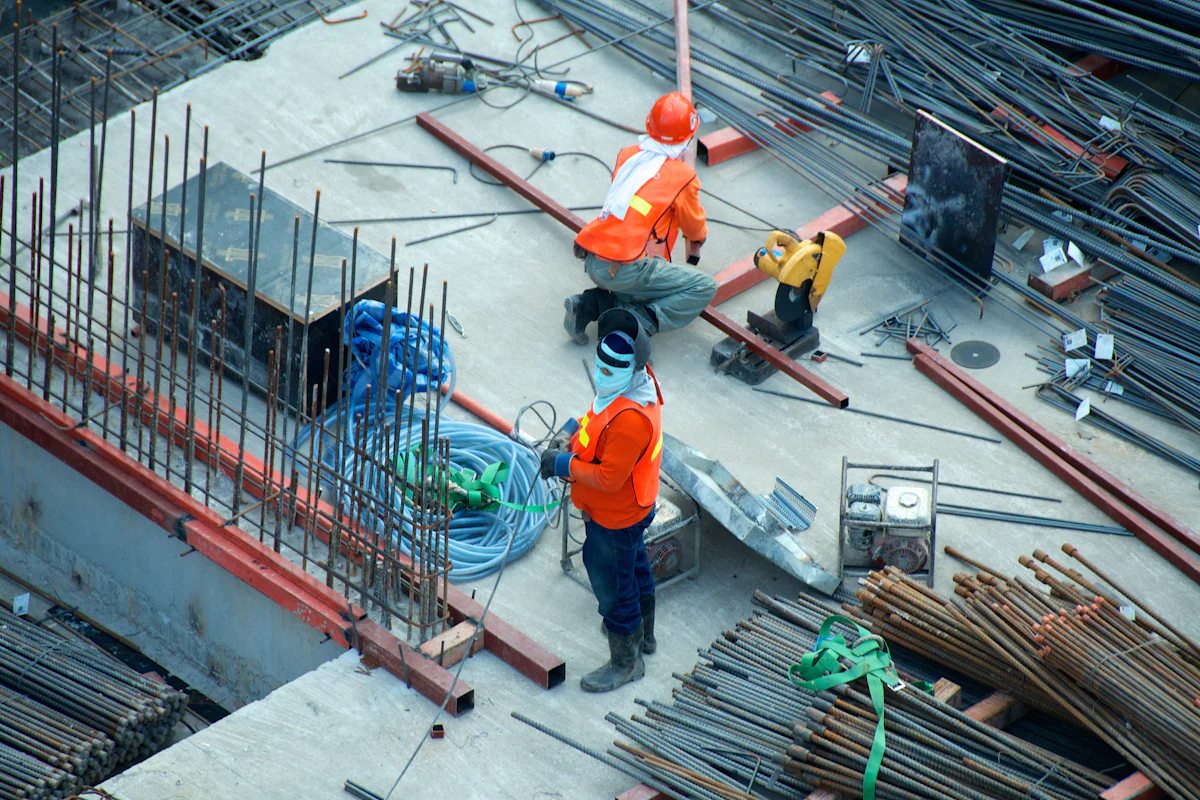 An overhead view of workers placing reinforcing steel on a concrete deck